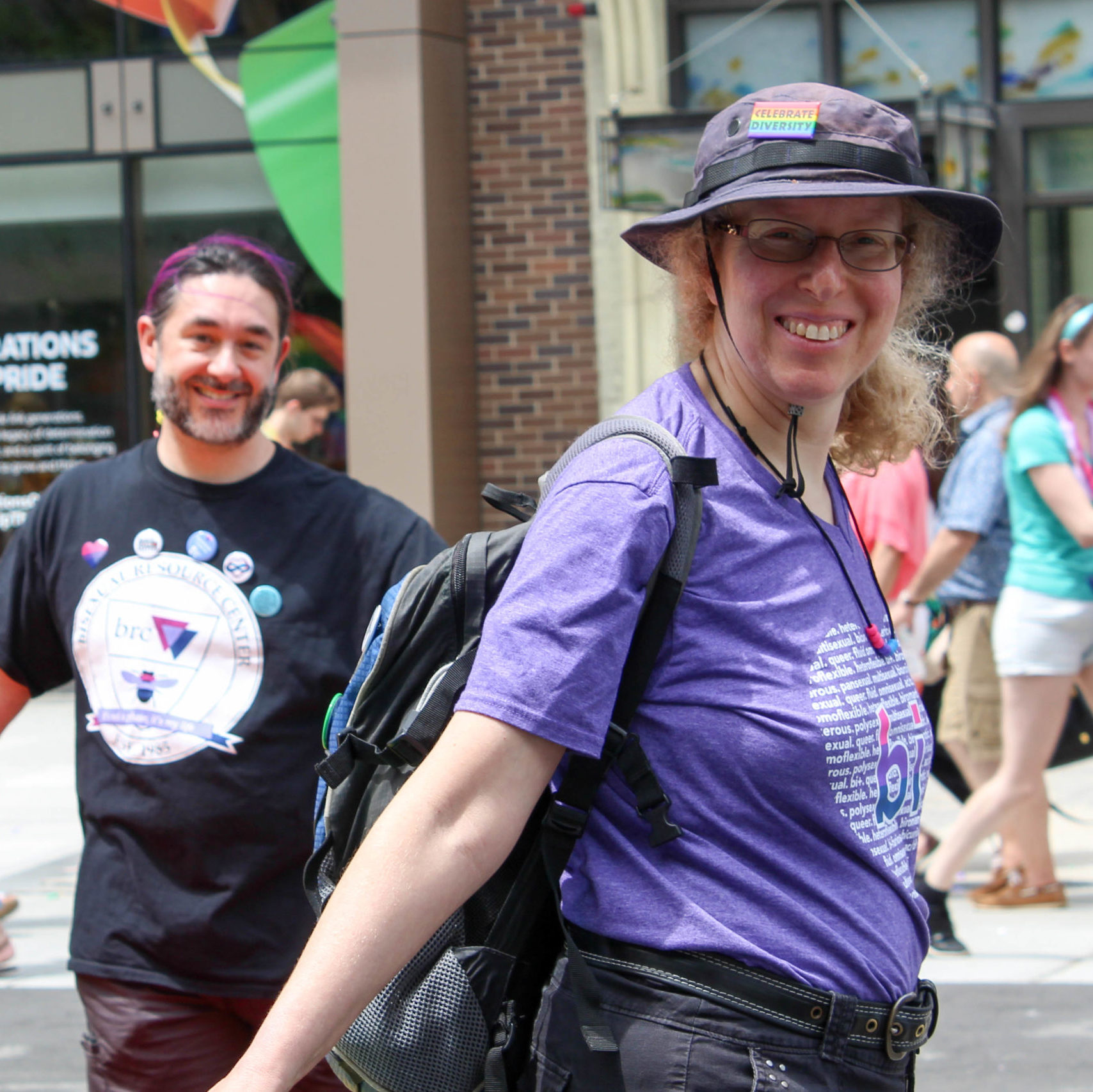 Two smiling people wearing BRC shirts