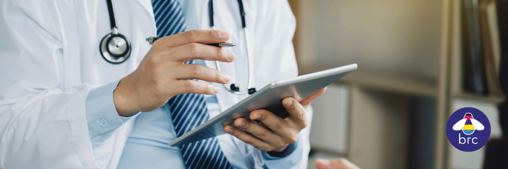 man in white coat with clipboard